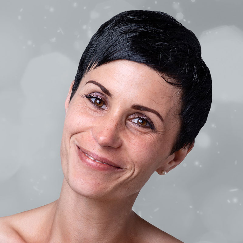 Woman with freckles and short black hair smiling